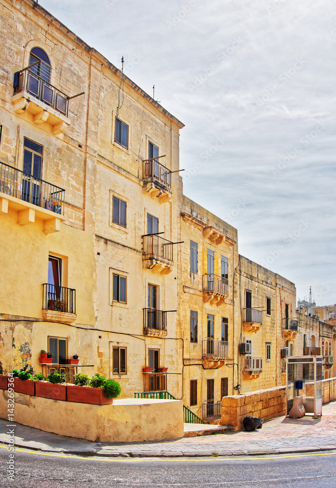 Street with traditional houses in old city center Valletta