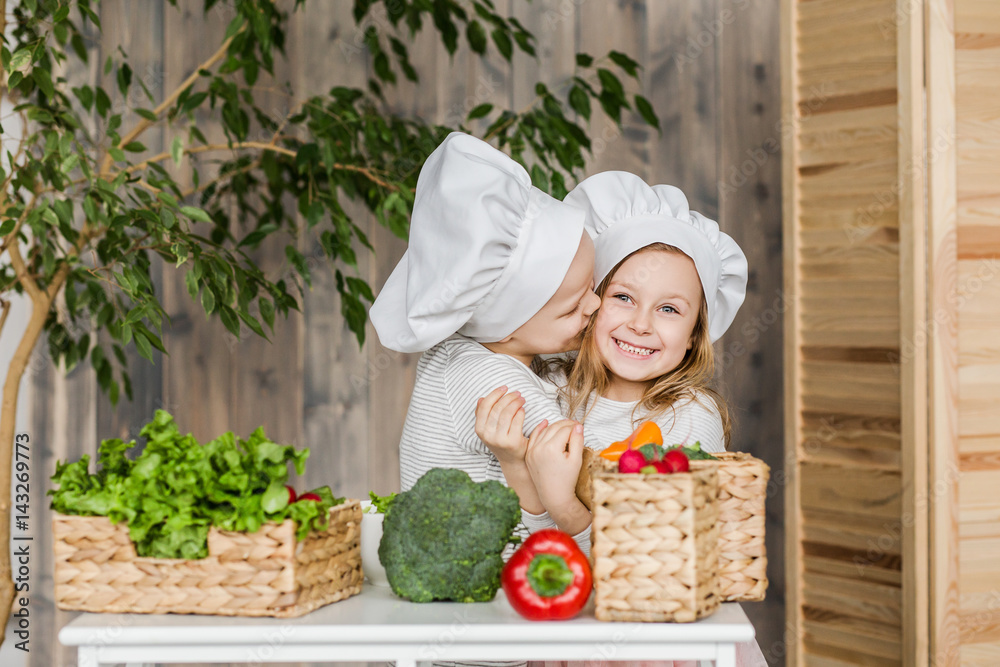 Kids in the kitchen making vegetable salads. Healthy food. Vegetables. Family