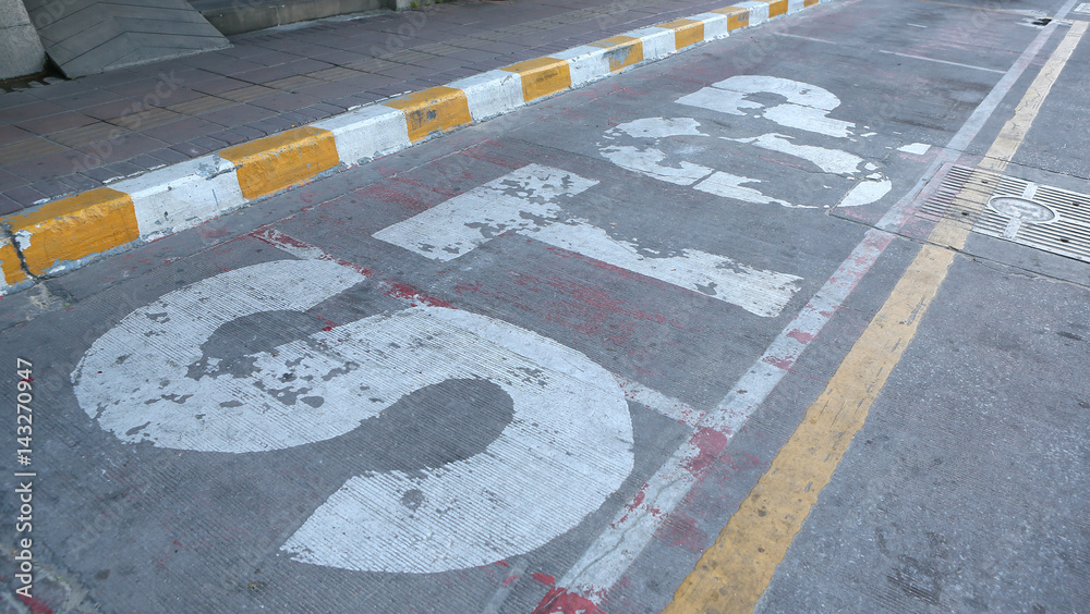 Fototapeta premium Old STOP sign painted on the road