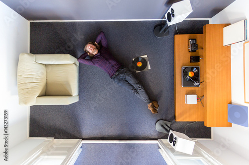 фотографія Man chilling out on the floor listening to music