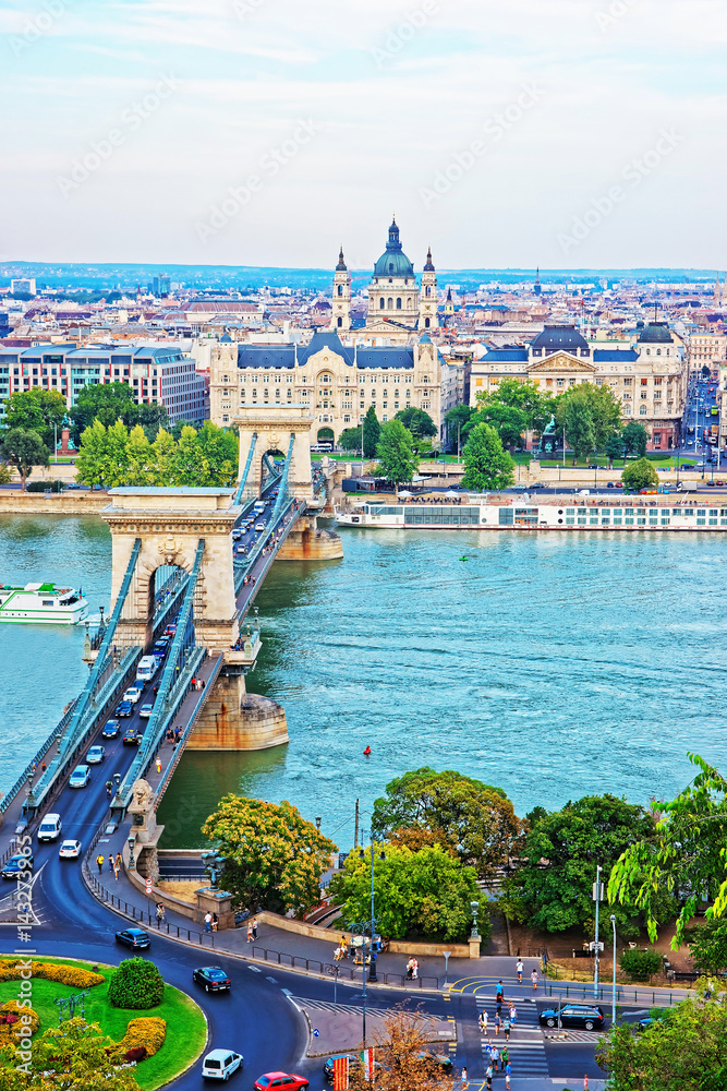 Chain Bridge above Danube River and Saint Stephen Basilica Budapest