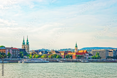 Ferry and Buda City with University Church Spire at Danube