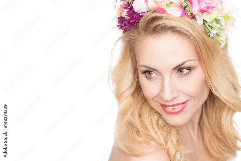 Timeless elegance. Horizontal portrait of a stunning mature woman with flowers in her hair smiling happily looking away copyspace on the side