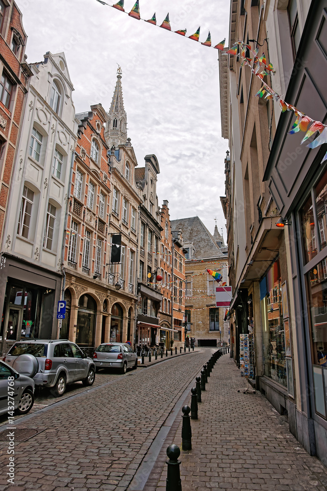 Narrow street with Town Hall spire in Brussels