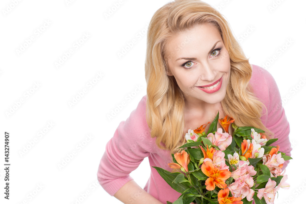 This is her day. Top view of a stunning beautiful mature woman smiling joyfully to the camera holding a bunch of flowers isolated on white