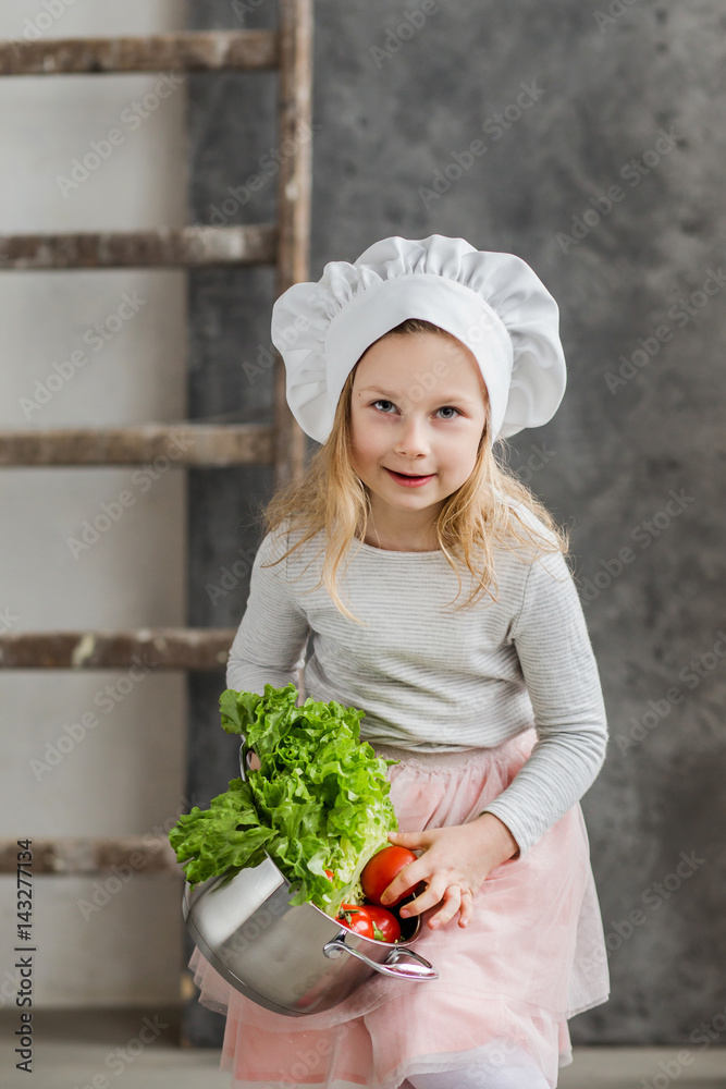 Little beautiful girl holding a pot full of vegetables. Healthy food. Harvest. Little housewife Little beautiful girl holding a pot full of vegetables. Healthy food. Harvest. Little housewife
