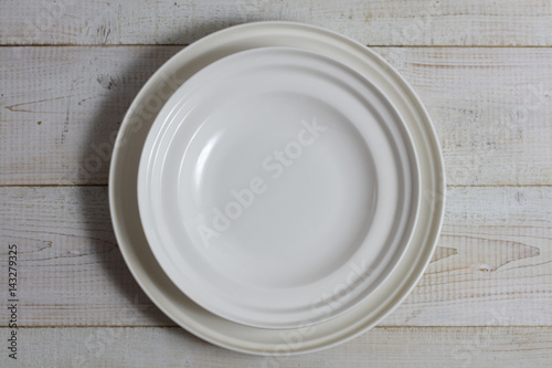 Empty plate on rustic wooden table. Minimalistic background