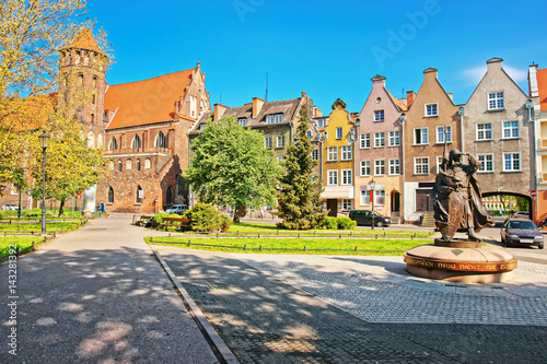 Statue of Duke of Gdansk and St Nicholas Church Gdansk photo