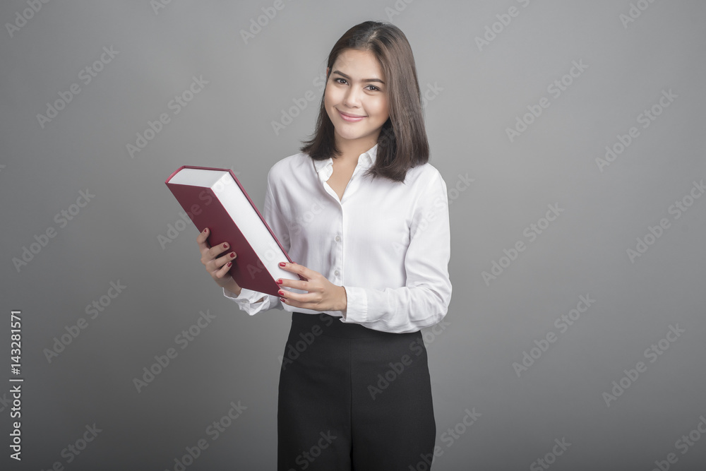 Beautiful teacher Woman holding book on grey background Beautiful teacher Woman holding book on grey background