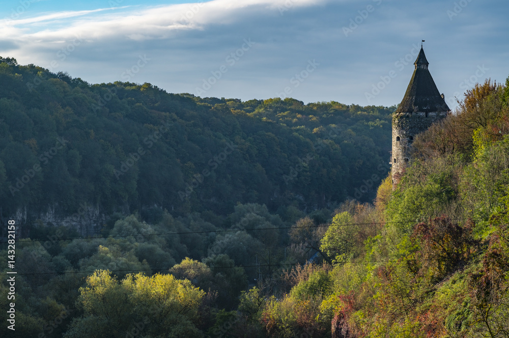 A watchtower above the canyon of the Smotrych River in Kamianets-Podilskyi, Western Ukraine. Trees are showing their autumn colours. A watchtower above the canyon of the Smotrych River in Kamianets-Podilskyi, Western Ukraine. Trees are showing their autumn colours.