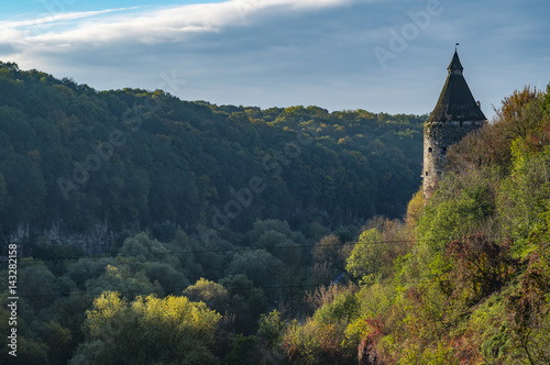 A watchtower above the canyon of the Smotrych River in Kamianets-Podilskyi, Western Ukraine. Trees are showing their autumn colours.