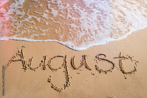 August written on beach, end of summer concept