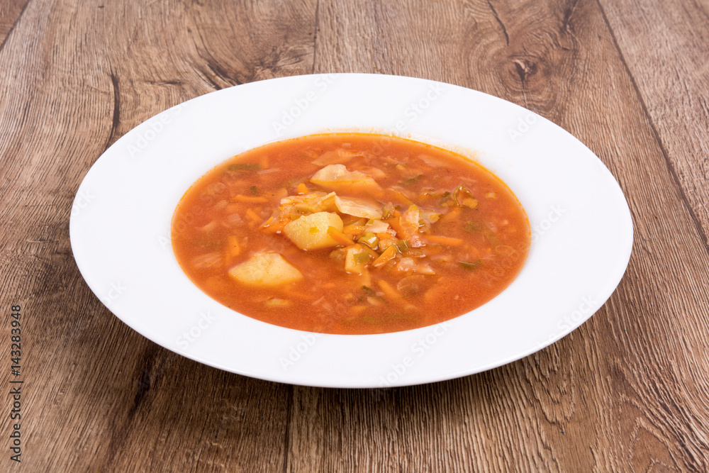 Vegetable soup on a wooden table Vegetable soup on a wooden table