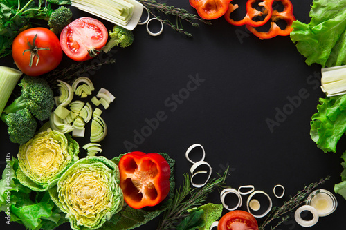 Frame of fresh vegetables on wooden background with copy space