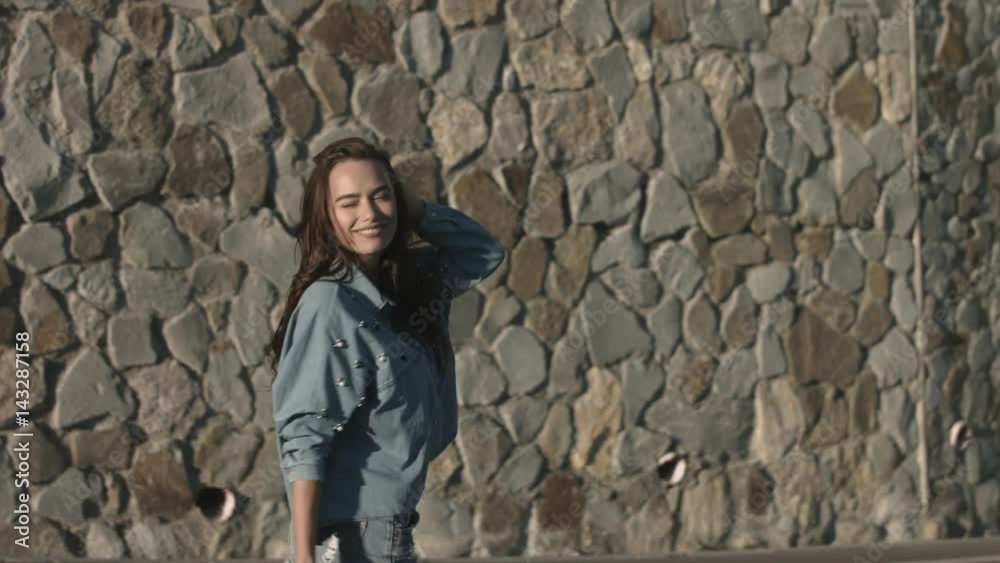 Pretty young woman walking along the road Pretty young woman walking along the road