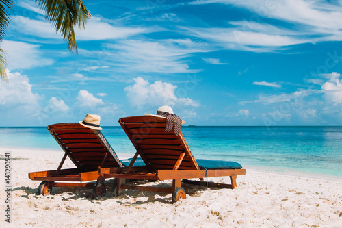 Fototapeta Naklejka Na Ścianę i Meble -  Two chairs on the tropical beach