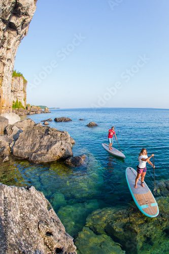 Attractive Young couple Stand Up Paddle Boarding