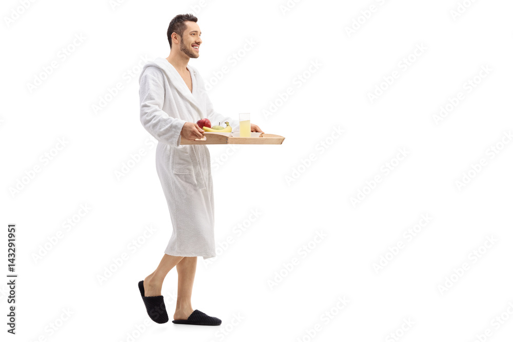 Guy in bathrobe walking and carrying tray with breakfast Guy in bathrobe walking and carrying tray with breakfast
