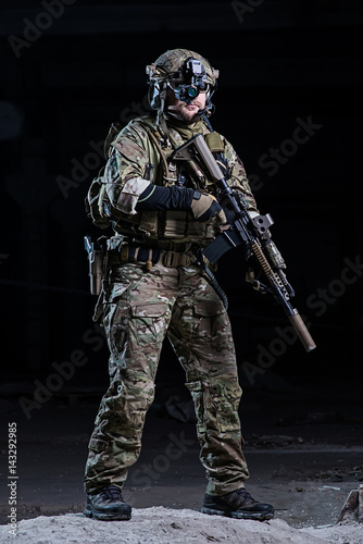 Soldier with night vision device and rifle/Soldier with night vision device,helmet with rifle on dark background
