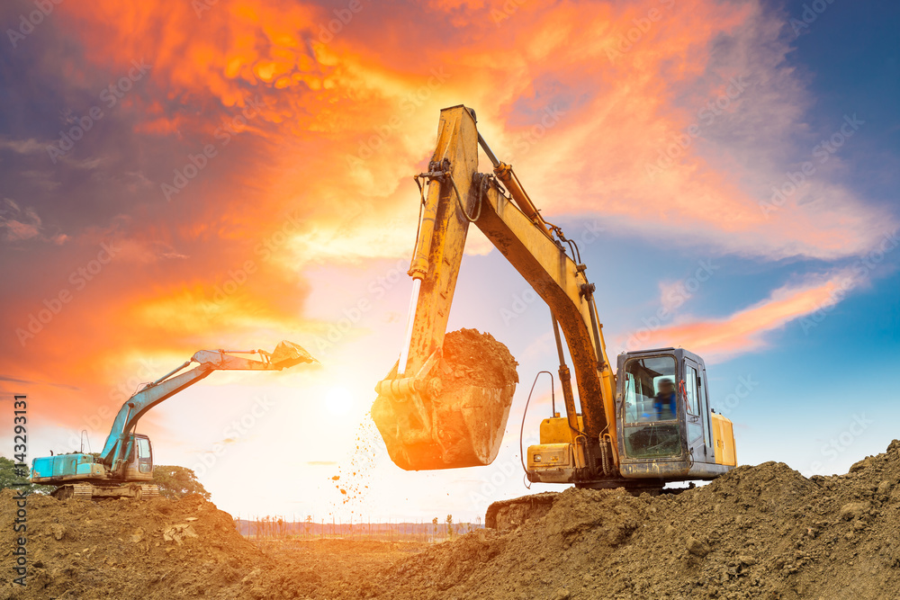 excavator in construction site on sunset sky background Stock Photo ...