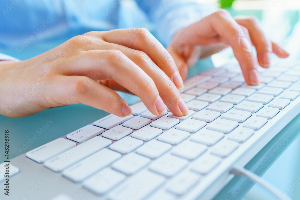 Woman office worker typing on the keyboard Woman office worker typing on the keyboard