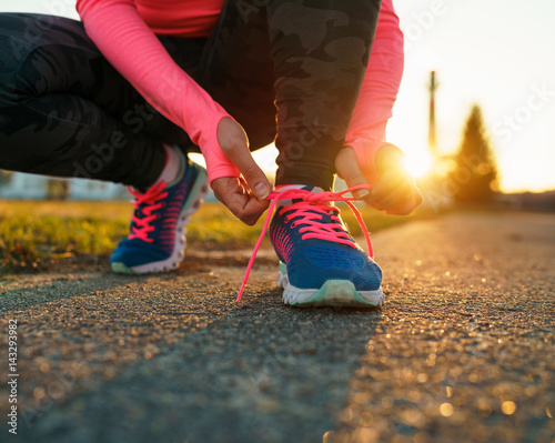 Running shoes - woman tying shoe laces