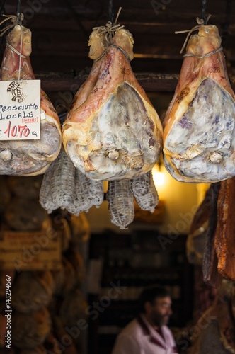 The famous Norcia's ham exposed in one of the many shops in the old town, Norcia, Italy photo