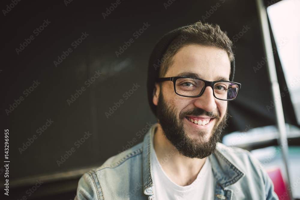 Portrait of bearded young man wearing glasses and hat Portrait of bearded young man wearing glasses and hat