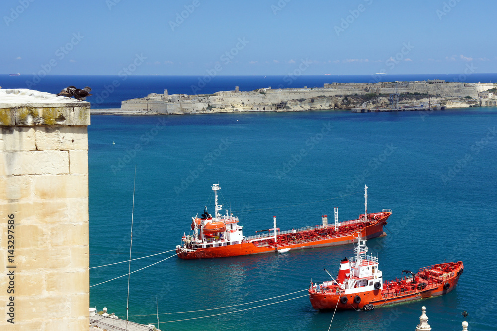 Malta.Two red ships in the blue water.