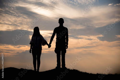 Silhouette of couple love on sunset, relax concept