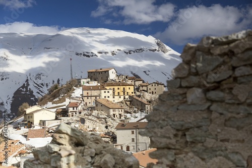 Castelluccio di Norcia, the old village destroyed by the earthquake of 2016, in the background the Vettore mount, Umbria, Italy photo