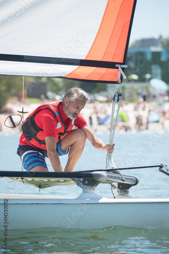 professional waterman training on lake with catamaran