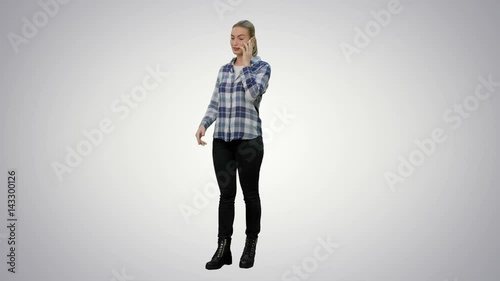 Young woman in casual talking gossips via cellphone on white background. photo