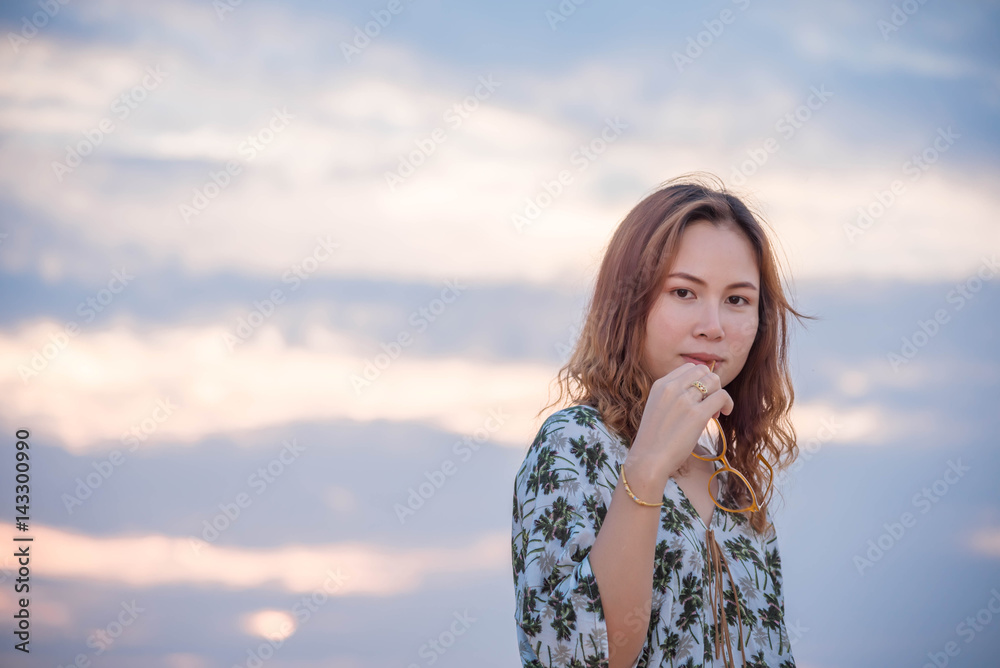 Young woman standing so sad on the mountein to sky background Young woman standing so sad on the mountein to sky background