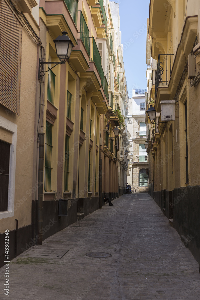Narrow street with traditional architecture in Cadiz, Andalusia, southern Spain