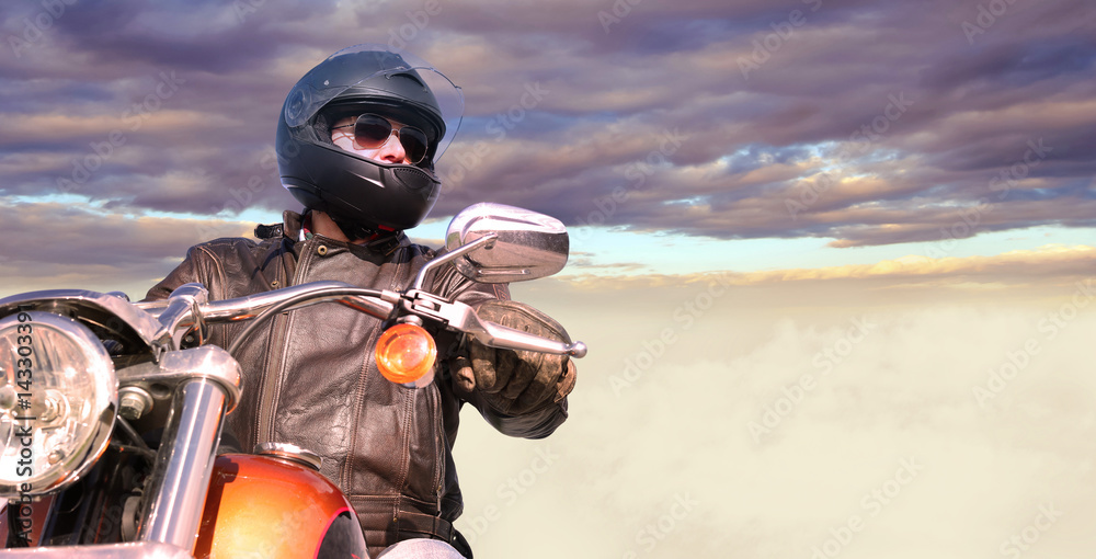 Biker On the road below beautiful sky Biker On the road below beautiful sky