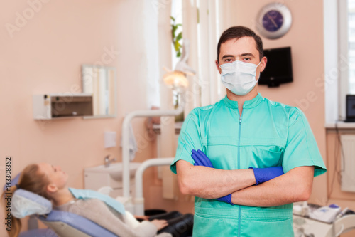 dentist standing with his hands crossed