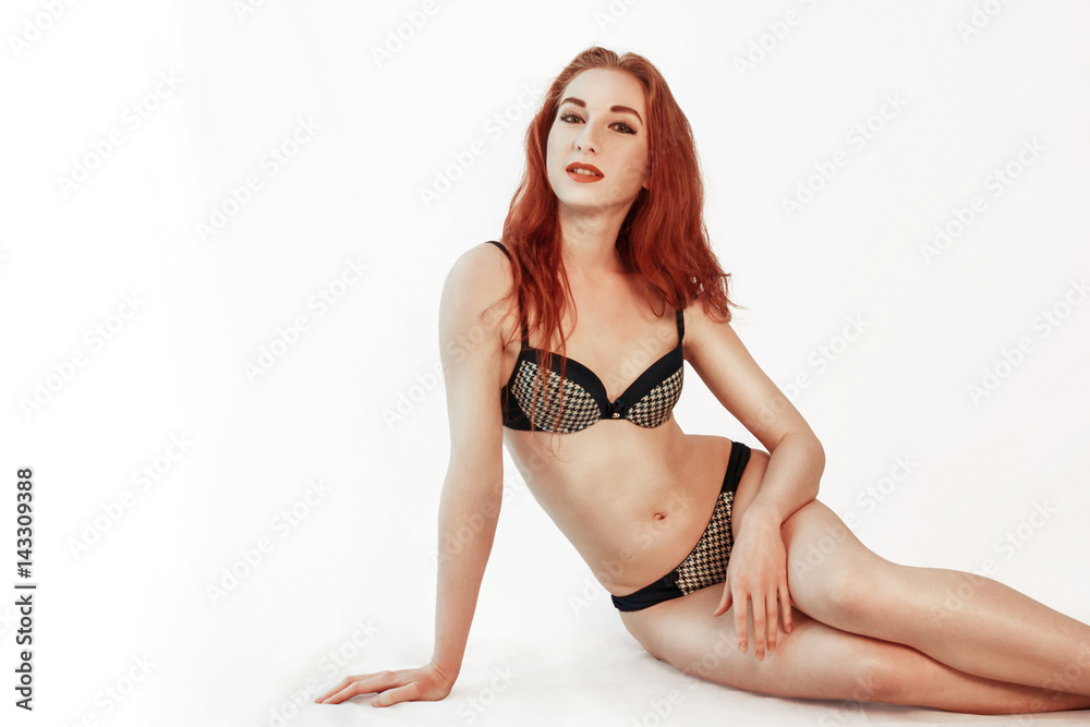 Lingerie redhead model in underwear sits on floor. attractive young redhead  woman in blue underwear sitting on floor. Isolated on white. Stock Photo |  Adobe Stock