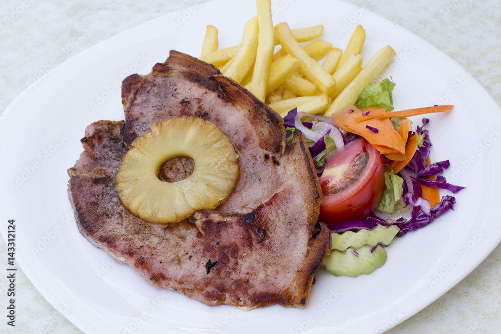 Fried Grilled pork steak on the bone with vegetables Fried Grilled pork steak on the bone with vegetables