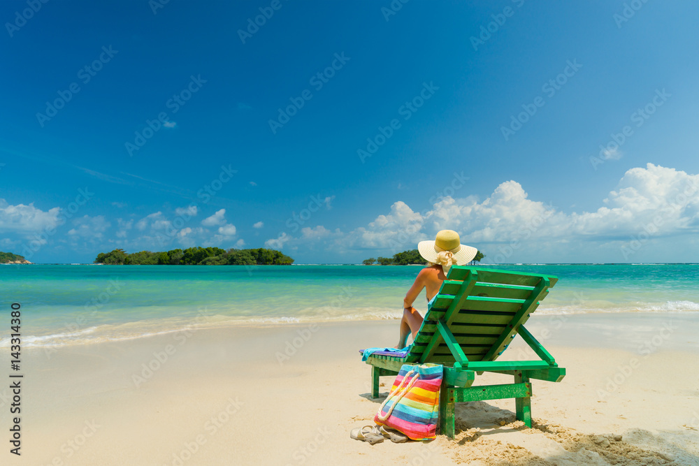 Woman sitting on a chair at the beach