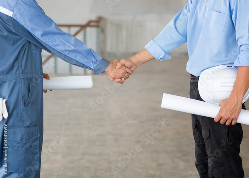 Close up group of Construction Asian civil engineer and foreman shake up their hand after achieve their mission or construction.