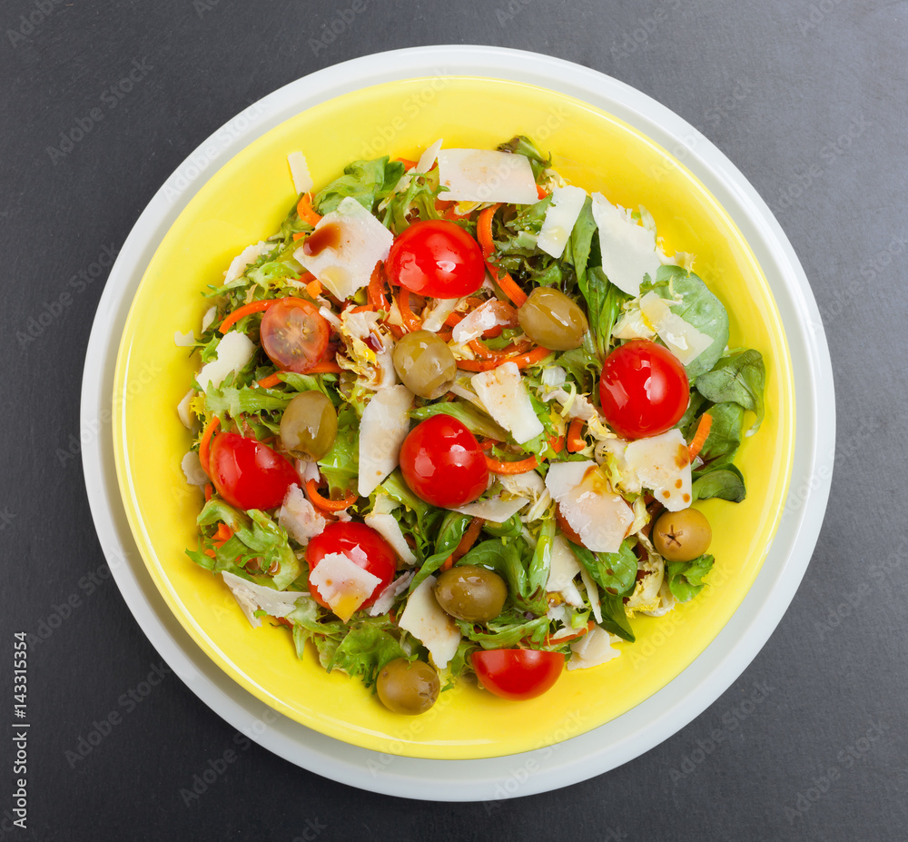 Mixed salad on black slate.