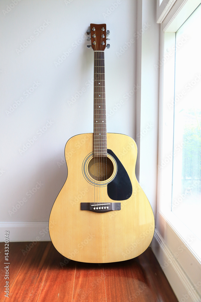 Fototapeta Guitar near the windows, as background.