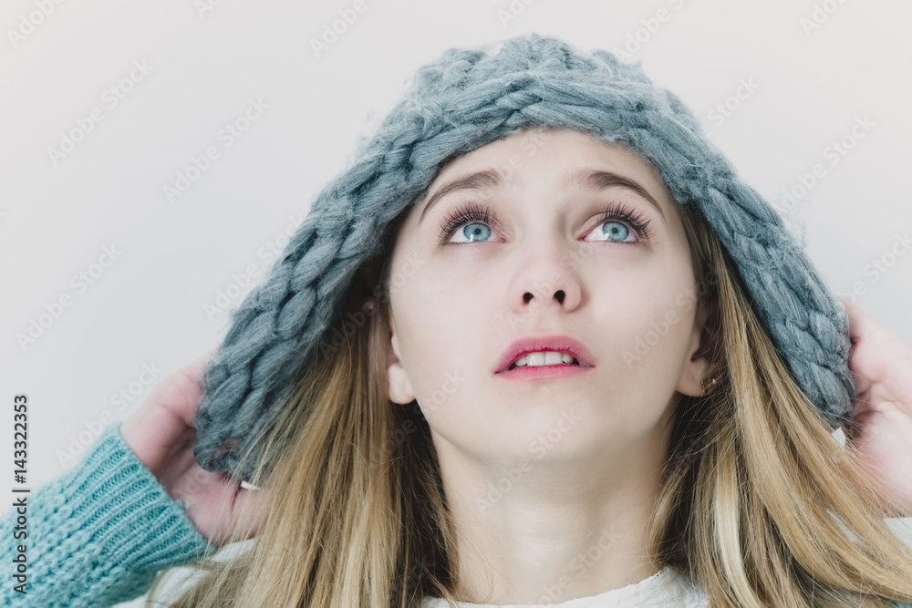 Pretty young girl with blond hair in fashionable sweater, hat Pretty young girl with blond hair in fashionable sweater, hat