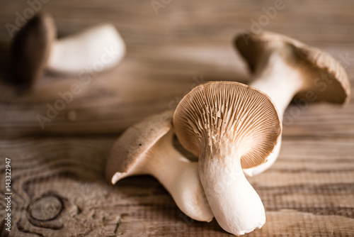 Fresh mushrooms on a wooden background. Rustic style. Selective focus