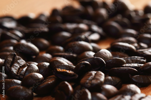 Roasted coffee beans espresso with a wood background