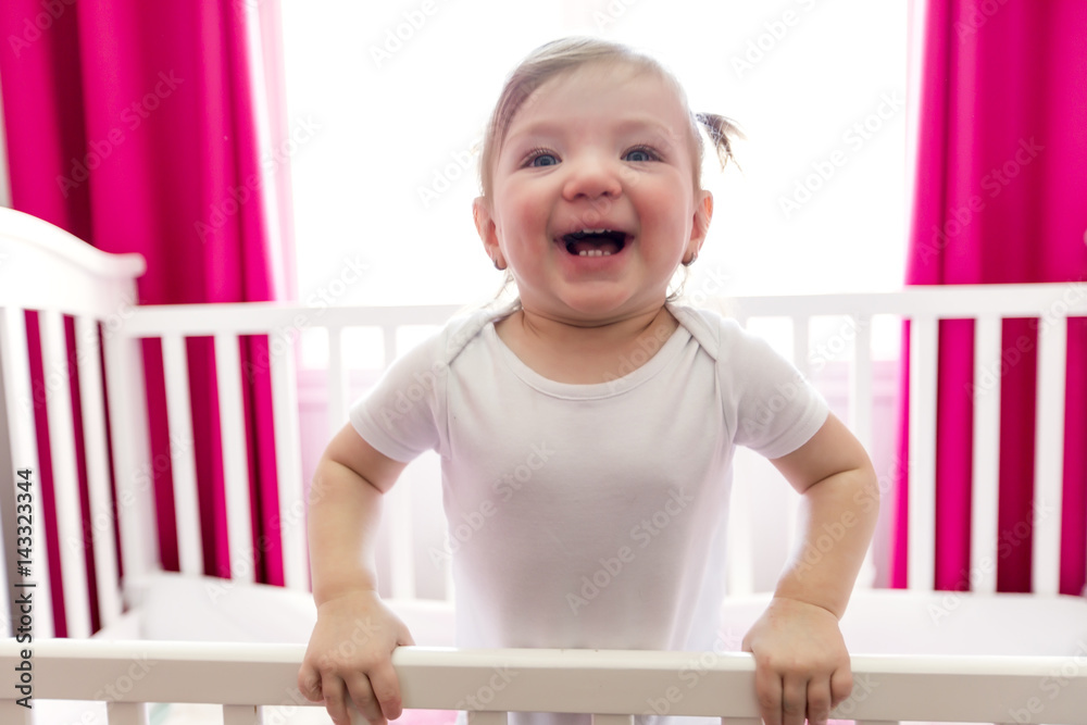 Cute little girl in cradle at baby room Cute little girl in cradle at baby room