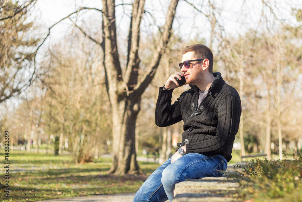 Young man with smartphone in the park Young man with smartphone in the park