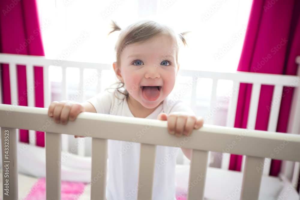 Cute little girl in cradle at baby room Cute little girl in cradle at baby room