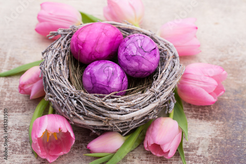 Easter eggs in the nest. Spring flowers tulips.